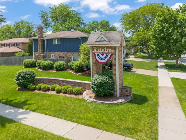 a sign board with a play ground in the back