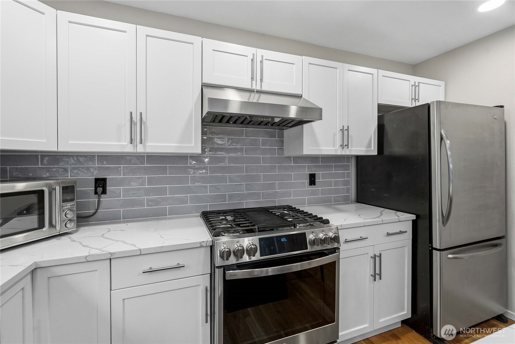 25010 235th Court Southeast Maple Valley, WA 98038 - Photo 13 of 40 a kitchen with stainless steel appliances white cabinets and a stove