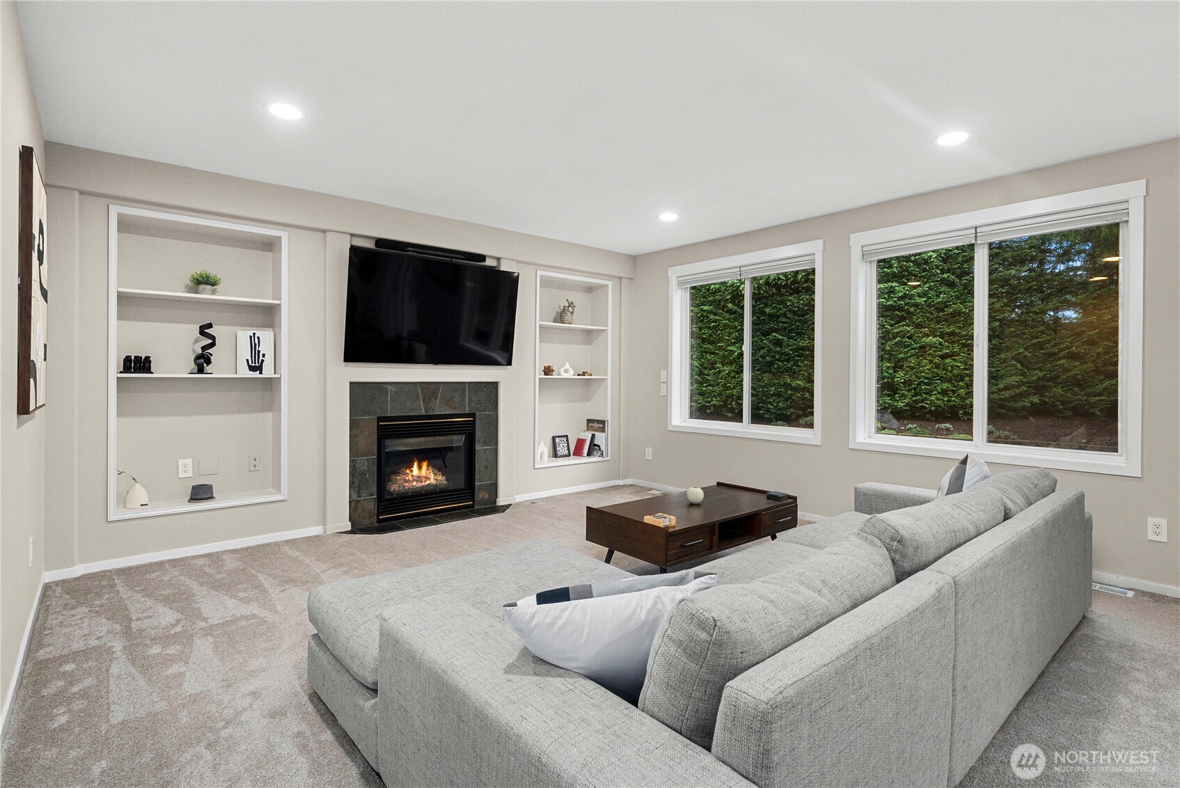 25010 235th Court Southeast Maple Valley, WA 98038 - Photo 18 of 40 a living room with furniture a flat screen tv and a fireplace