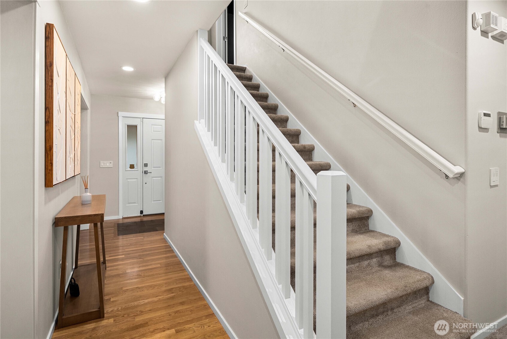 25010 235th Court Southeast Maple Valley, WA 98038 - Photo 23 of 40 a view of staircase with lots of frames on wall and wooden floor