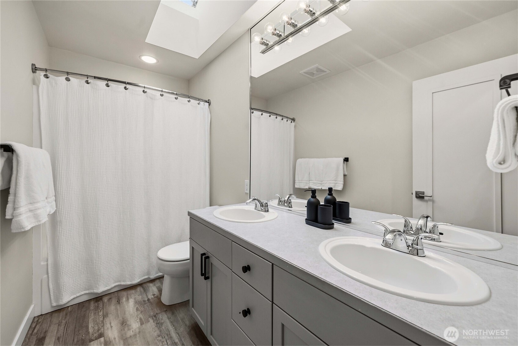 25010 235th Court Southeast Maple Valley, WA 98038 - Photo 35 of 40 a bathroom with double vanity sink a mirror and a shower