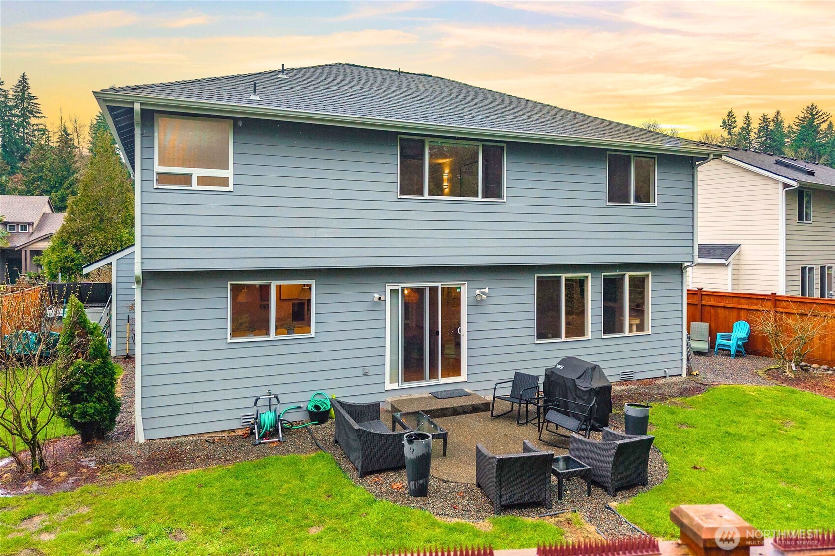 25010 235th Court Southeast Maple Valley, WA 98038 - Photo 36 of 40 a brick house with couches chairs and a yard with wooden fence