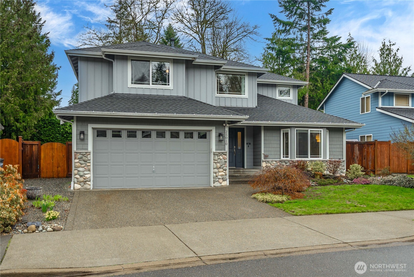 25010 235th Court Southeast Maple Valley, WA 98038 - Photo 4 of 40 a front view of a house with garden