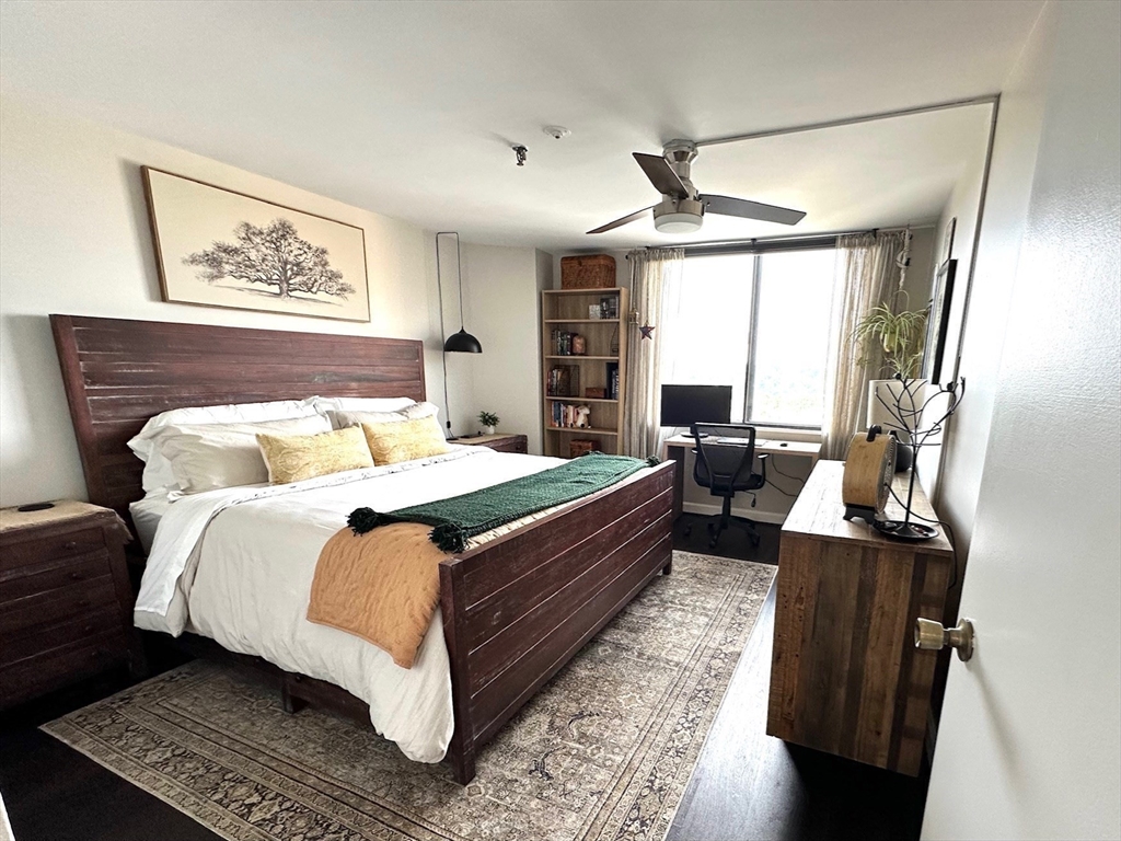77 Adams Street, Unit 902 Quincy, MA 02169 - Photo 16 of 36 a bedroom with a large bed and a couch