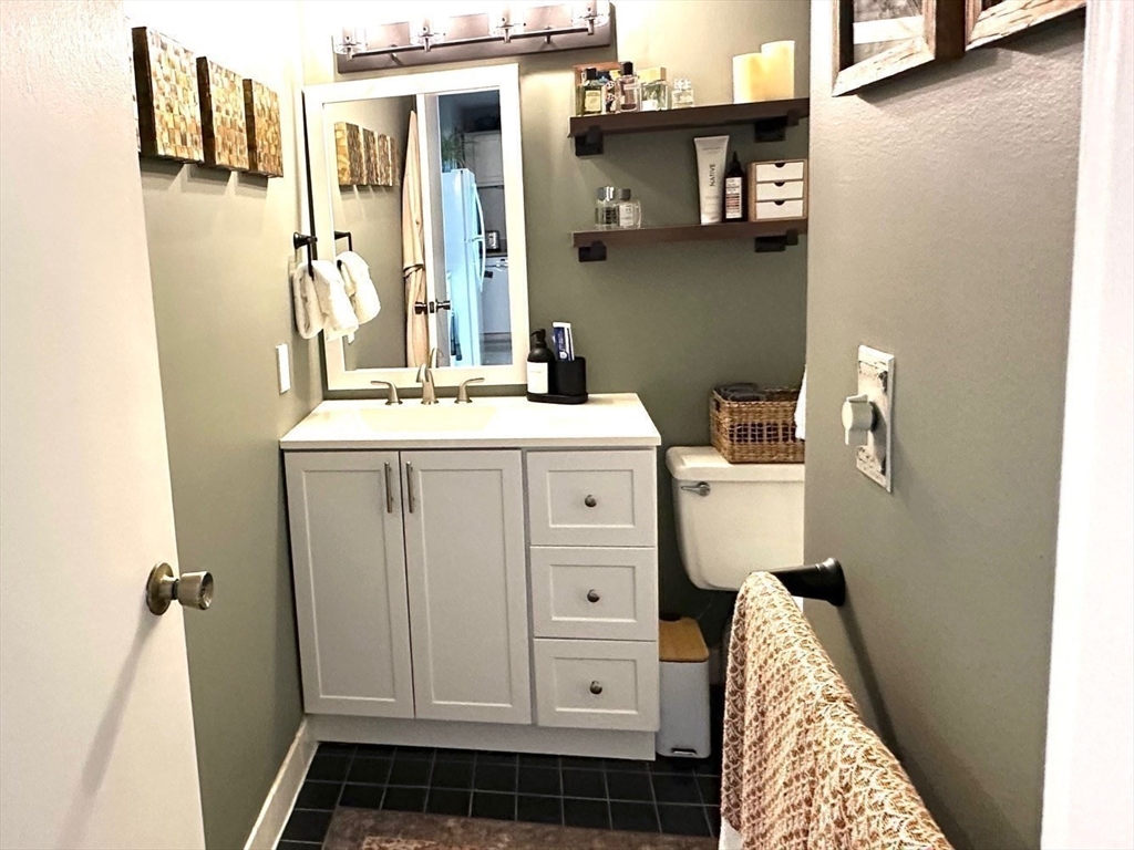 77 Adams Street, Unit 902 Quincy, MA 02169 - Photo 20 of 36 a bathroom with a sink and a mirror
