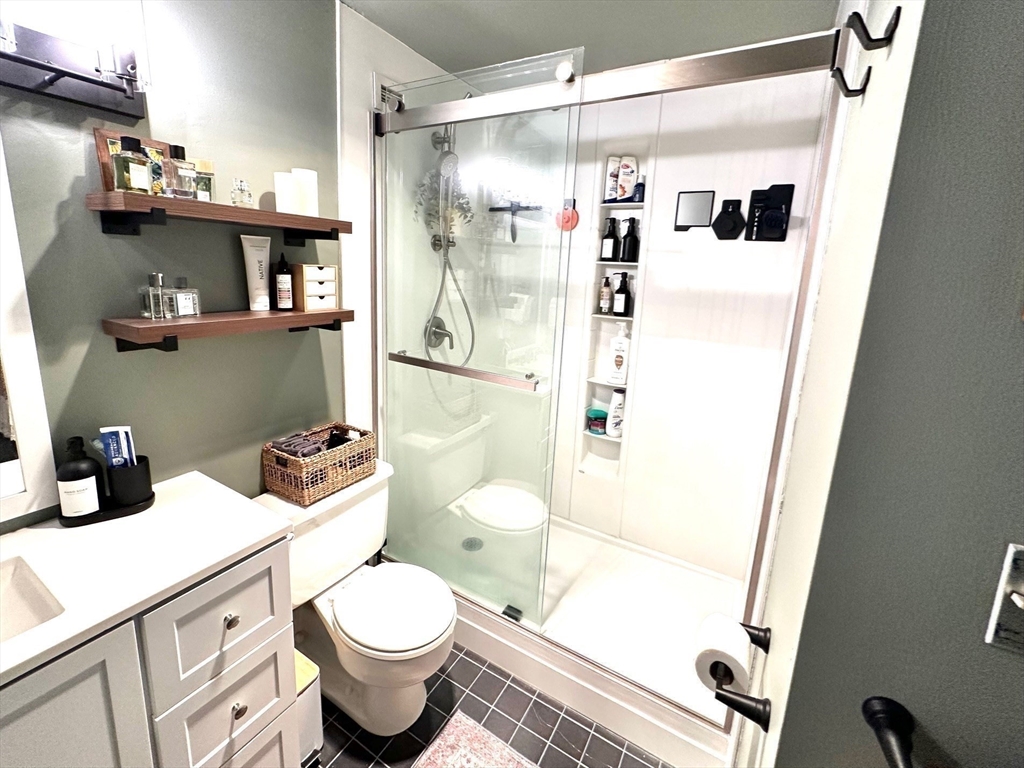 77 Adams Street, Unit 902 Quincy, MA 02169 - Photo 21 of 36 a bathroom with a shower toilet and sink