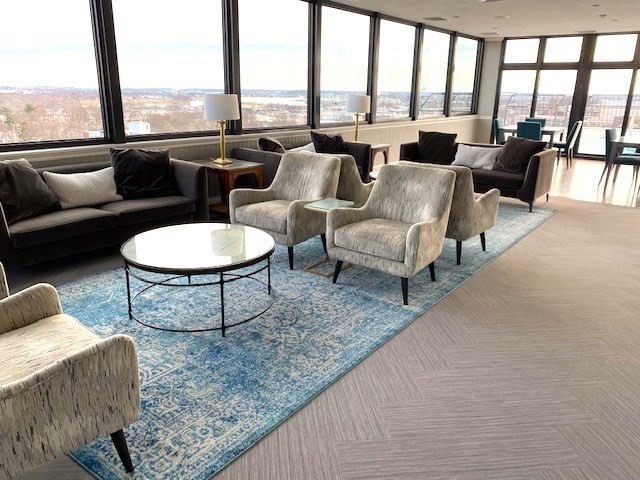 77 Adams Street, Unit 902 Quincy, MA 02169 - Photo 24 of 36 a living room with furniture and a floor to ceiling window