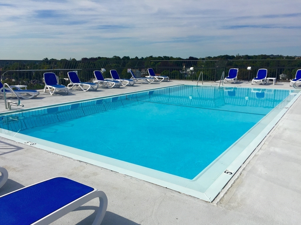 77 Adams Street, Unit 902 Quincy, MA 02169 - Photo 26 of 36 a view of a swimming pool and an outdoor seating