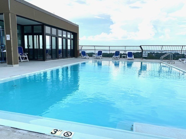 77 Adams Street, Unit 902 Quincy, MA 02169 - Photo 27 of 36 a view of a swimming pool with an outdoor seating