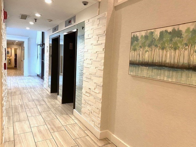 77 Adams Street, Unit 902 Quincy, MA 02169 - Photo 32 of 36 a view of a hallway with wooden floor
