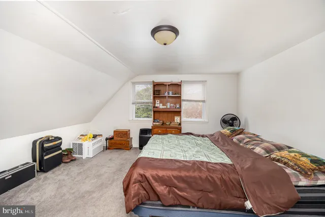 a bedroom with a bed and dresser