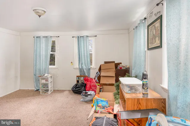 a room with furniture a rug toys and a window