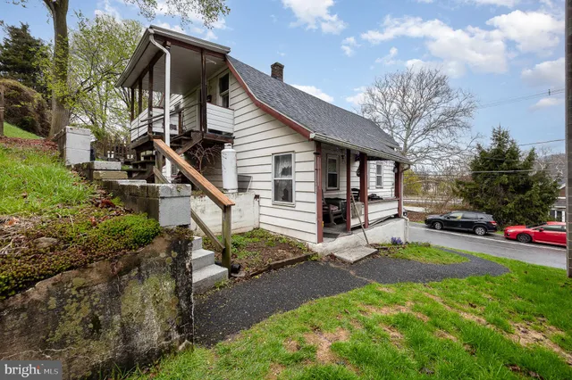 a view of a house with backyard porch and sitting area