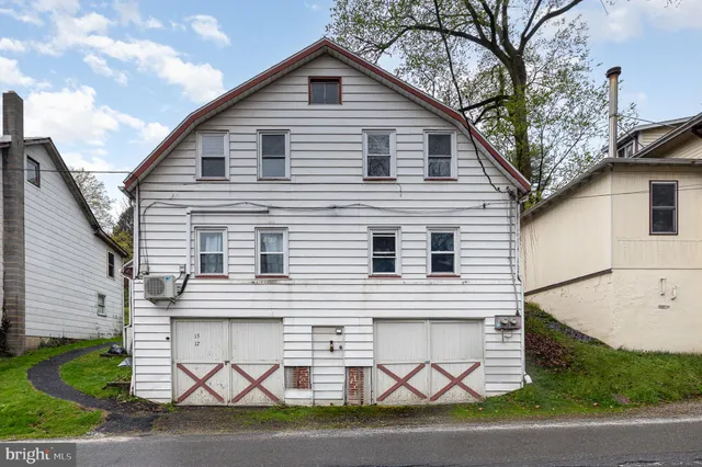 a view of a white house with a large space