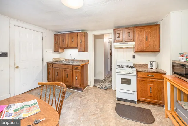 a kitchen with a stove a sink and a refrigerator