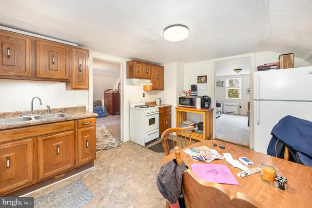 a bed room with a bed and a refrigerator