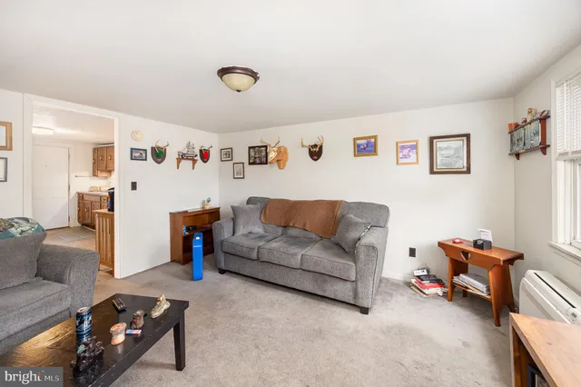 a living room with furniture and a bookshelf