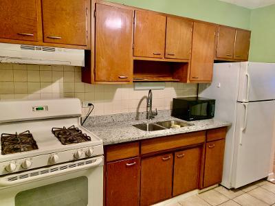7019 North Ridge Boulevard, Unit 2C Chicago, IL 60645 - Photo 12 of 12 a kitchen with stainless steel appliances granite countertop a sink stove and refrigerator