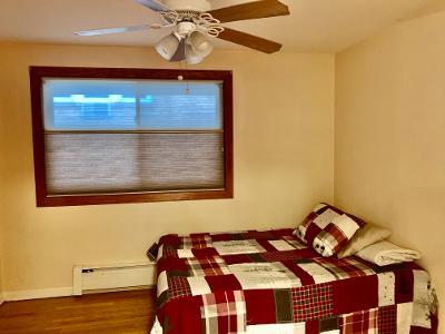 7019 North Ridge Boulevard, Unit 2C Chicago, IL 60645 - Photo 7 of 12 a bedroom with a bed and a window