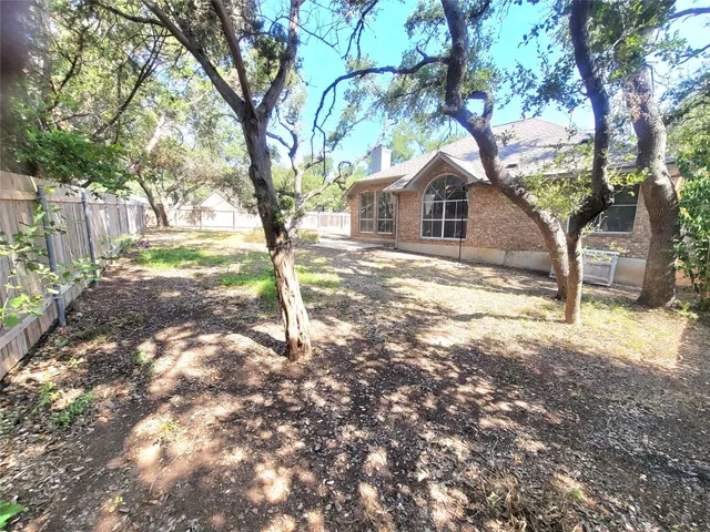 a white house in middle of the forest