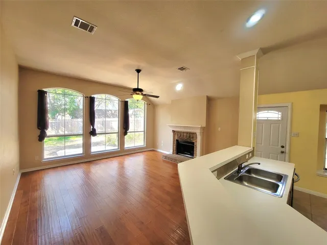 a view of kitchen with sink and wooden floor