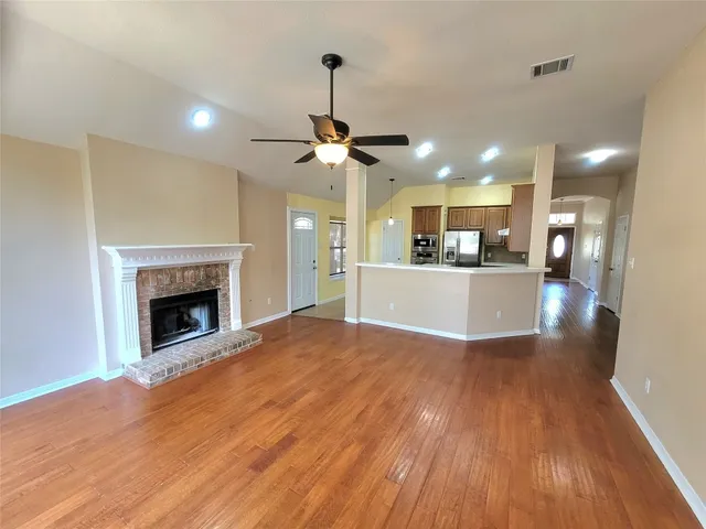 a view of a kitchen with a sink and a fireplace