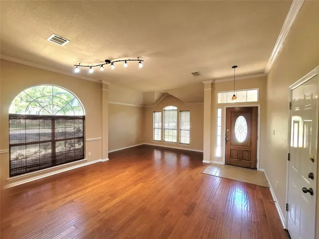 wooden floor in an empty room with a window