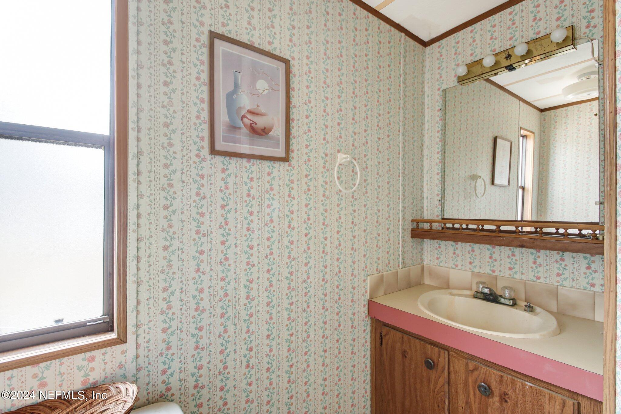 125 Crows Bluff Road Satsuma, FL 32189 - Photo 15 of 31 a bathroom with a sink and a mirror