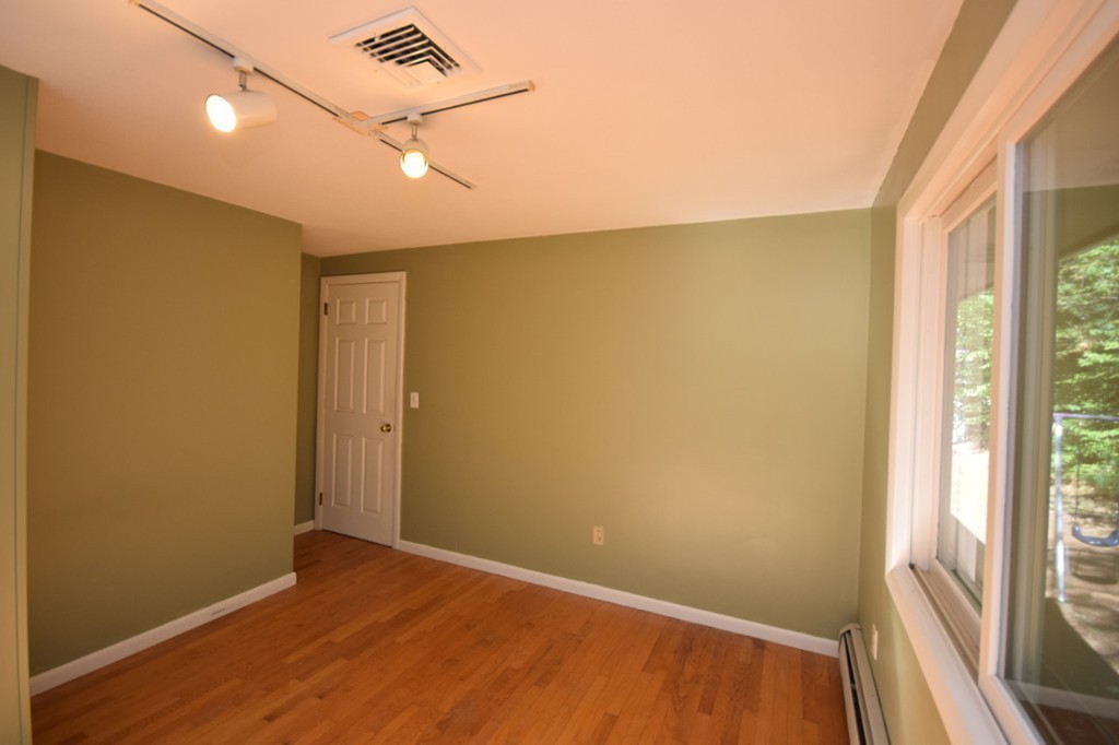 9 Ely Road Wilbraham, MA 01095 - Photo 11 of 26 a view of empty room with wooden floor and fan