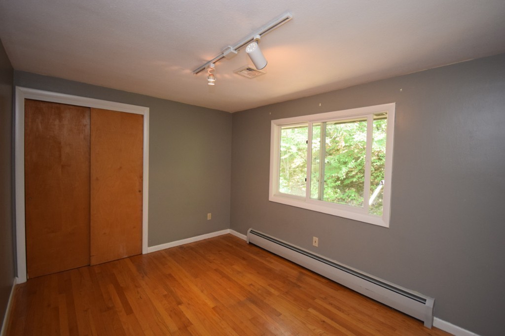 9 Ely Road Wilbraham, MA 01095 - Photo 12 of 26 an empty room with wooden floor and windows