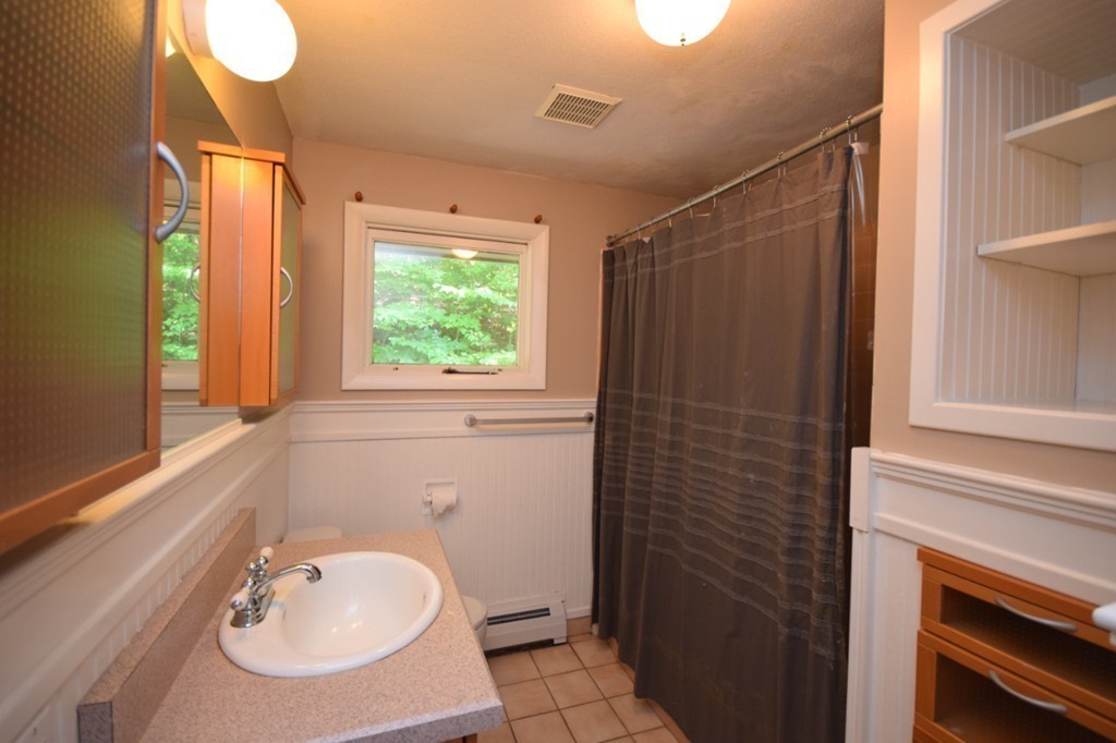 9 Ely Road Wilbraham, MA 01095 - Photo 14 of 26 a bathroom with a sink a mirror and a window