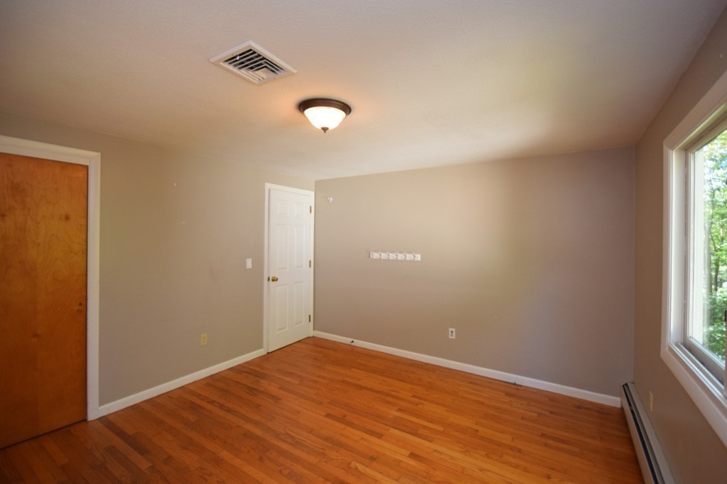 9 Ely Road Wilbraham, MA 01095 - Photo 22 of 26 an empty room with wooden floor and windows