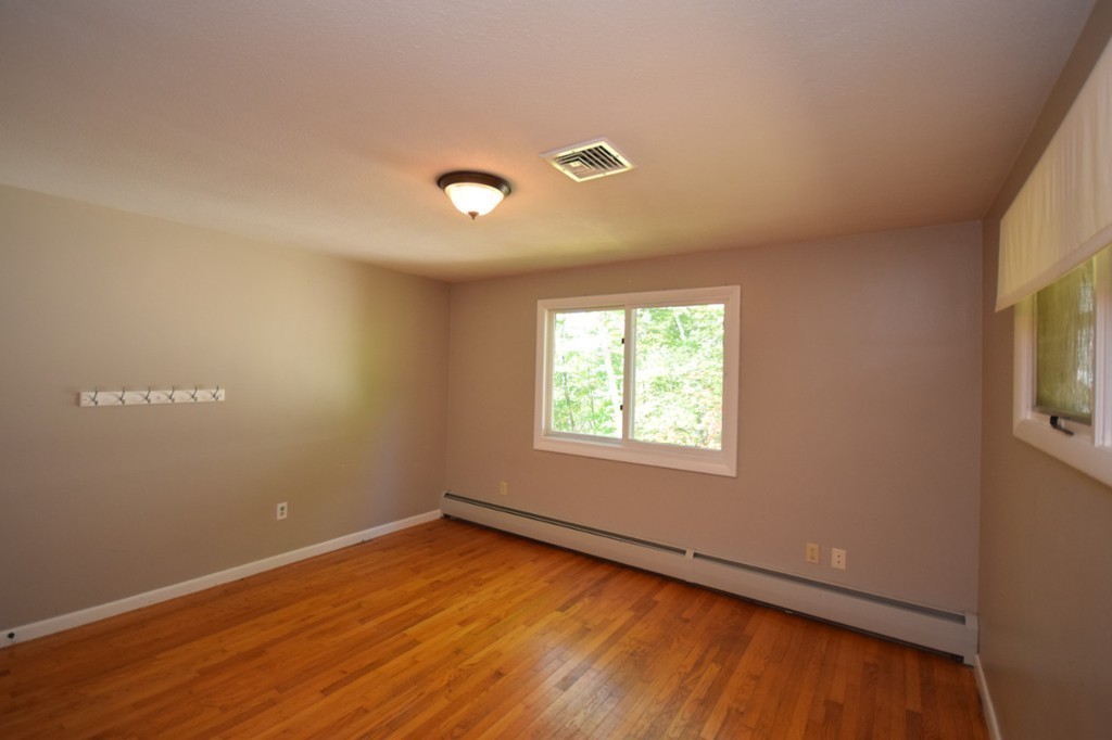 9 Ely Road Wilbraham, MA 01095 - Photo 23 of 26 an empty room with wooden floor and windows