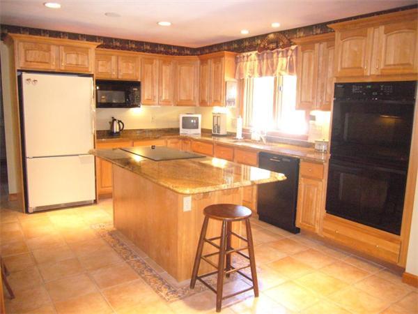 219 Hayden Road Groton, MA 01450 - Photo 3 of 29 a kitchen with a refrigerator a stove a sink and a cabinets