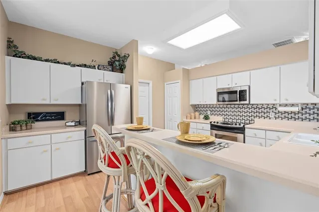 a kitchen with a sink appliances and cabinets
