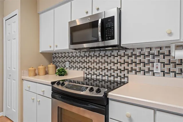 a kitchen with a stove and a microwave