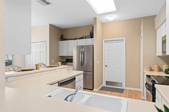 a room with a refrigerator and a sink