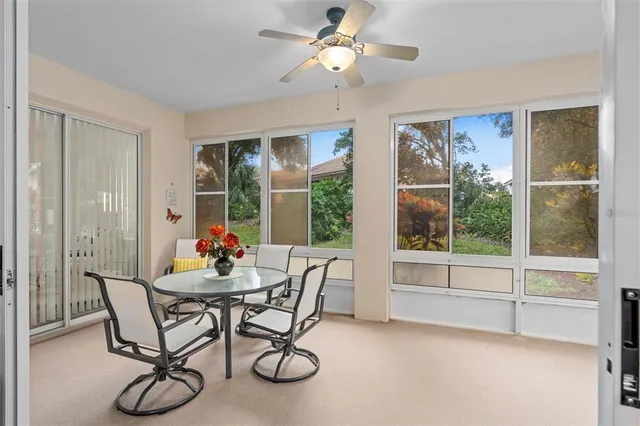 a dining room with furniture window and outside view