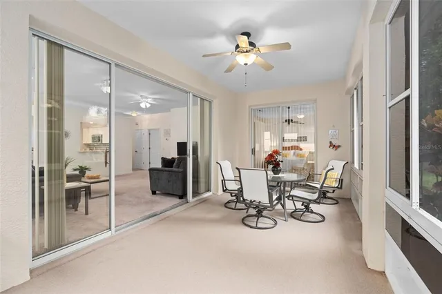 a view of a dining room with furniture a livingroom and chandelier