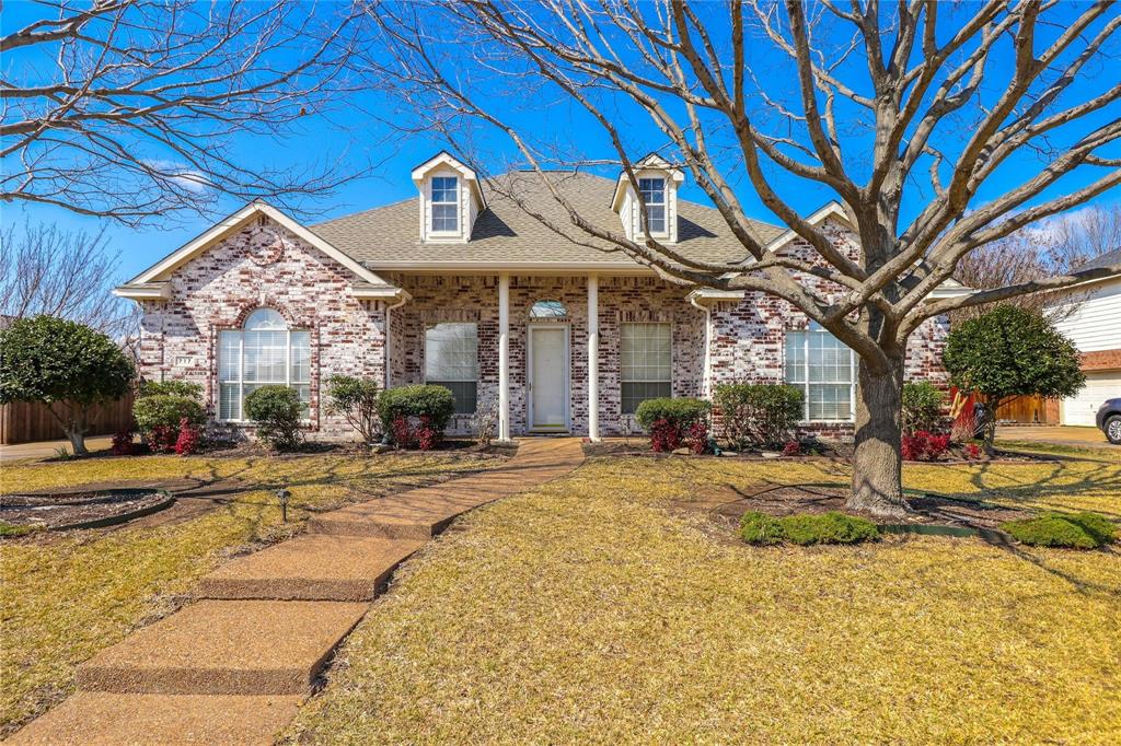 717 Summerfield Drive Murphy, TX 75094 - Photo 1 of 1 View of front facade with brick siding, a shingled roof, and a front yard