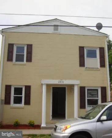 a view of a building with a car parked in front of it