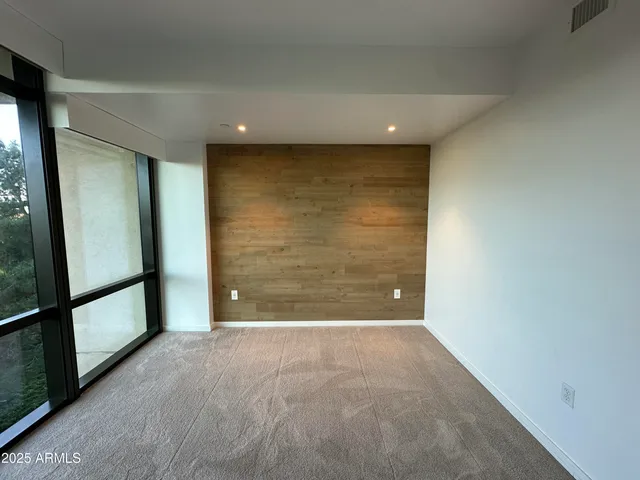 a view of a balcony with wooden floor and fence
