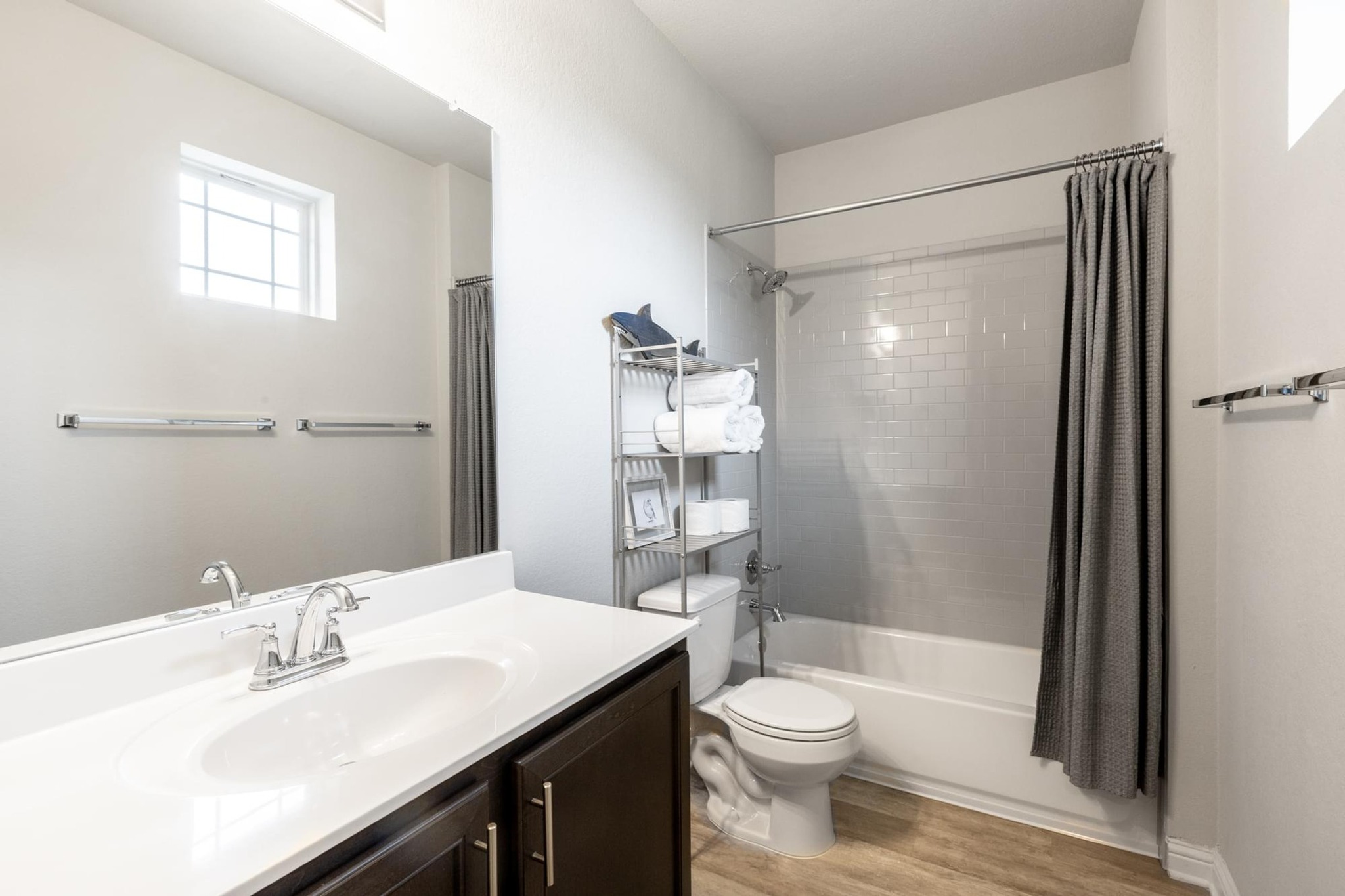 7801 Frida Bend Austin, TX 78744 - Photo 17 of 26 A well-appointed bathroom features a single vanity, tub, and toilet, all with contemporary fixtures.
