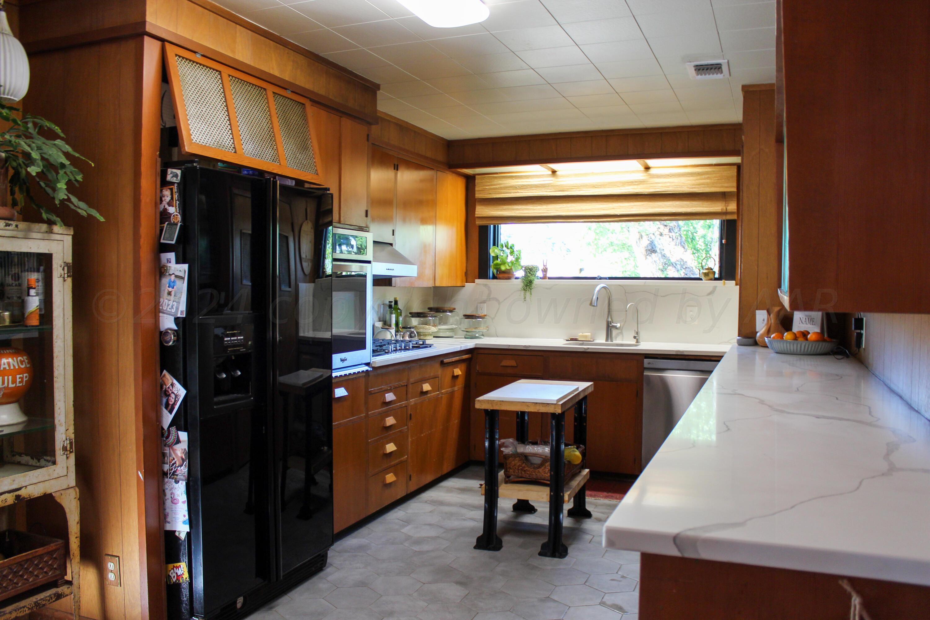 710 Park Avenue Panhandle, TX 79068 - Photo 15 of 26 a kitchen with stainless steel appliances granite countertop sink refrigerator and window