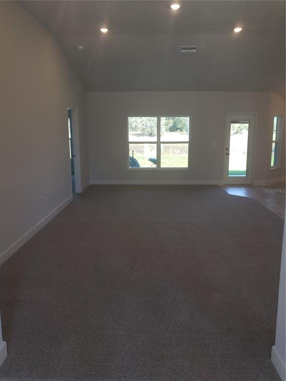 278 Waterfall Drive Spring Hill, FL 34608 - Photo 4 of 16 an empty room with windows