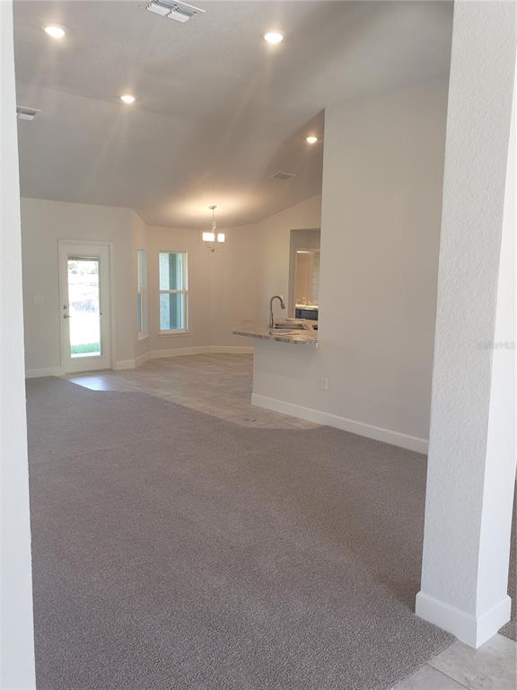278 Waterfall Drive Spring Hill, FL 34608 - Photo 5 of 16 an empty room with windows and pillars in it