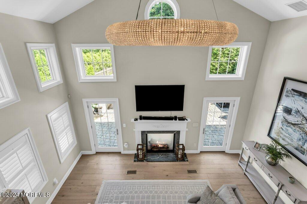 3 Ruddy Court Little Silver, NJ 07739 - Photo 13 of 55 a living room with furniture a flat screen tv and a fireplace