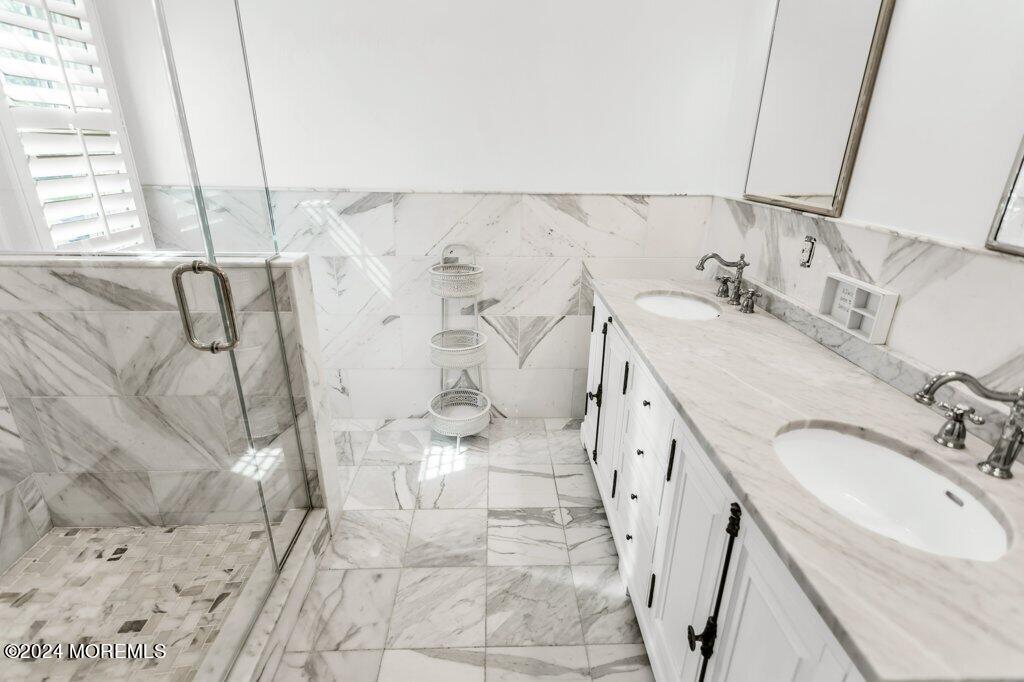 3 Ruddy Court Little Silver, NJ 07739 - Photo 24 of 55 a spacious bathroom with a granite countertop sink a mirror and shower