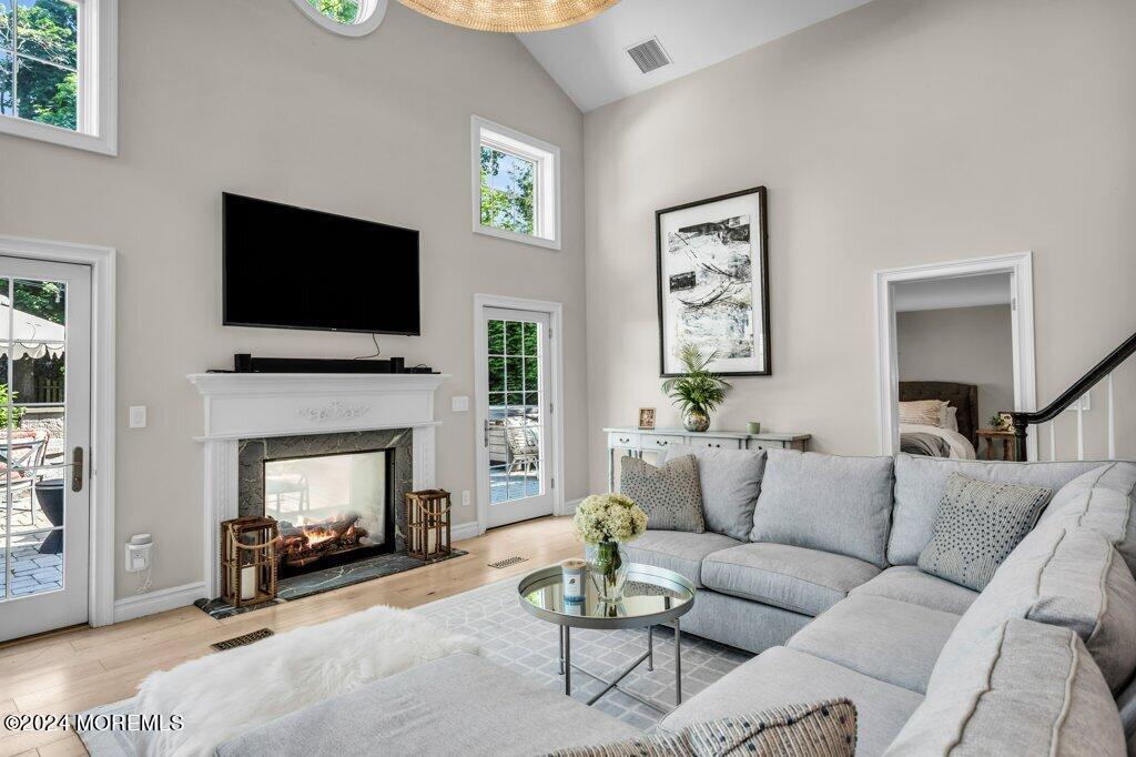 3 Ruddy Court Little Silver, NJ 07739 - Photo 40 of 55 a living room with furniture a flat screen tv and a fireplace