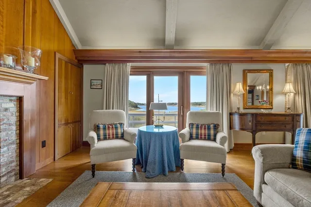 a living room with furniture a table and a large window